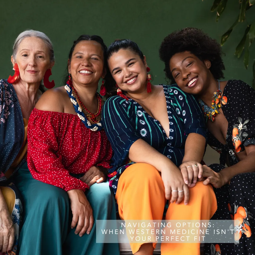 Four diverse women sit and smile together, radiating positivity