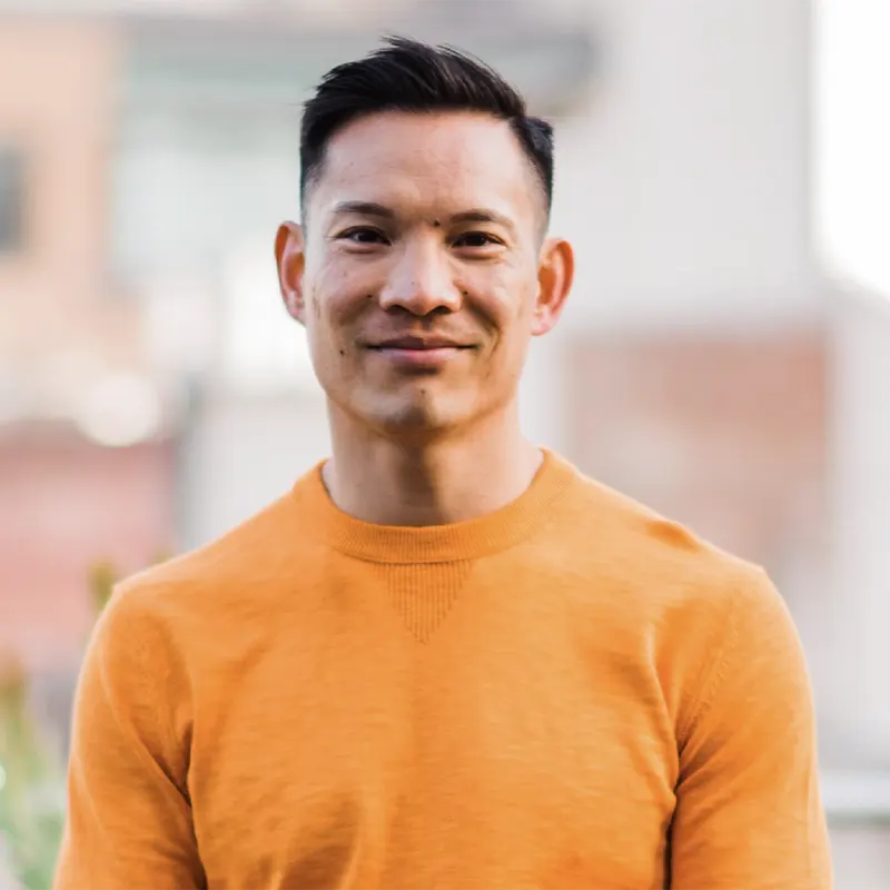 Advisory Council Member, Jason Luk. An Asian man with brown hair, wearing an orange shirt